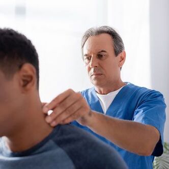 The doctor conducts a diagnostic examination of a patient with neck pain